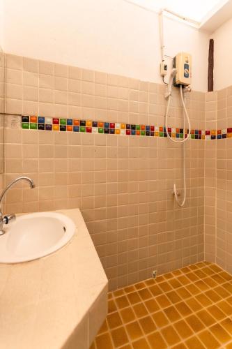 a bathroom with a sink and a shower at Guru Resort Chiang Mai in Ban Muang Ha