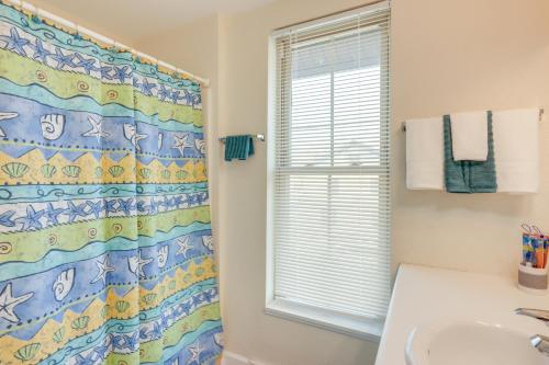 a bathroom with a shower curtain and a sink at Delafield Vacation Rental Near Lakes and Parks! in Delafield