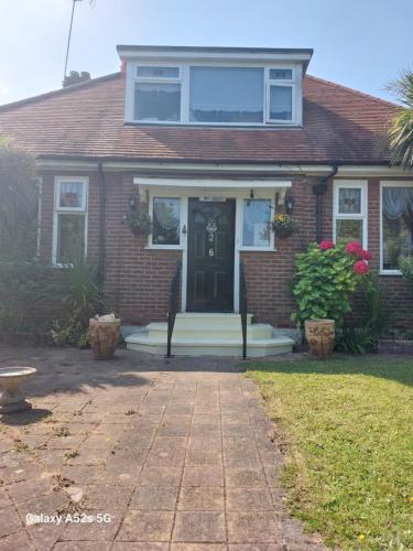 a red brick house with a black door at Nest Guesthouse in Margate