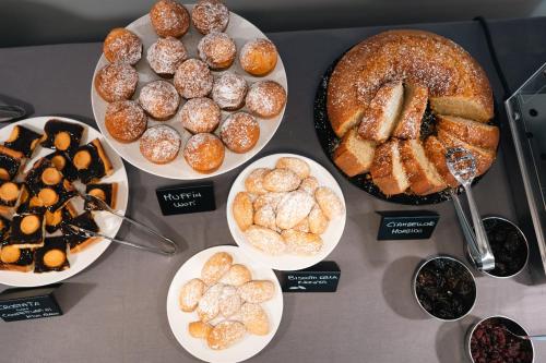 a table with plates of different types of pastries at Hotel Parnaso in Trebisacce