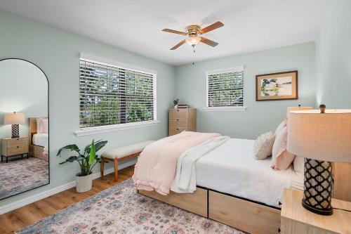 a bedroom with a bed and a ceiling fan at Lakeside Lilypad Wonderland Kayak Grill Firepit in Green Cove Springs