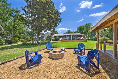 a group of blue chairs sitting around a fire pit at Lakeside Lilypad Wonderland Kayak Grill Firepit in Green Cove Springs