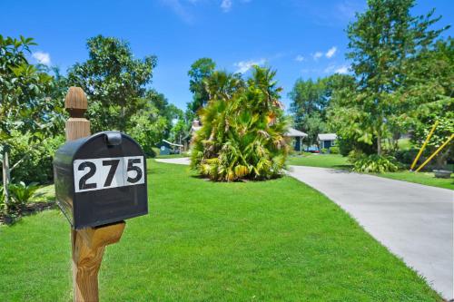 a mailbox with the number on it next to a driveway at Lakeside Lilypad Wonderland Kayak Grill Firepit in Green Cove Springs