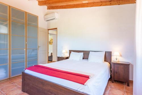 a bedroom with a large white bed in a room at Sa Teulera Soller in Sóller