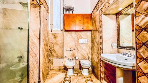 a bathroom with a toilet and a sink at GALA Apartments - Charme Barocco a due passi da Piazza Duomo in Lecce