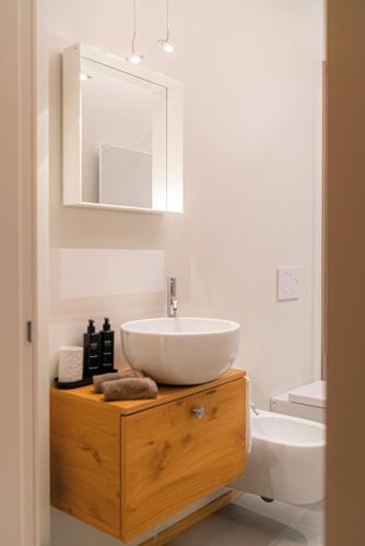 a white bathroom with a sink and a toilet at LEONI DI COLLALTO PALACE in Treviso