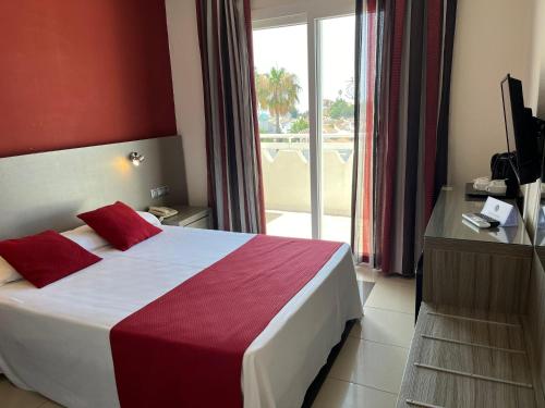 a hotel room with a bed and a large window at Hotel Nerja Club by Dorobe in Nerja