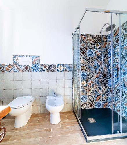 a bathroom with a toilet and a shower stall at BeB MaLú in Torpè