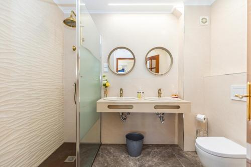 a bathroom with a sink and two mirrors at Casa Pink Flamingo Spacious Town Centre Villa in Tavira