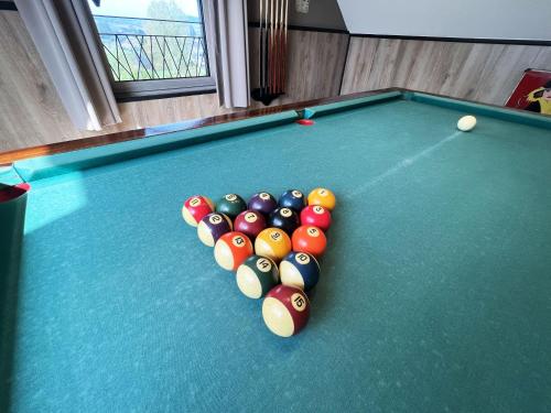 a felt pool table with a heart of billiard balls at Lu T Chene in Opont