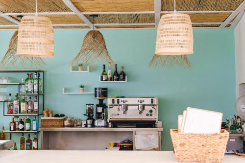 a kitchen with blue walls and two hanging baskets at Hotel Ankaa - Adults Only in Porto Cristo