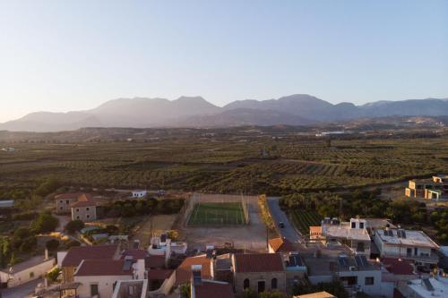 an aerial view of a village with mountains in the background at Stone house Elefteria near Matala beach in Petrokefálion