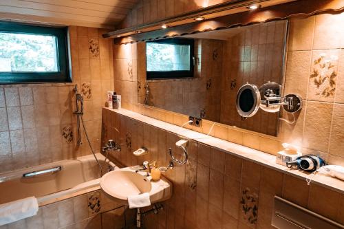 a bathroom with a sink and a mirror at Big quiet Villa with garden and pool in Vienna