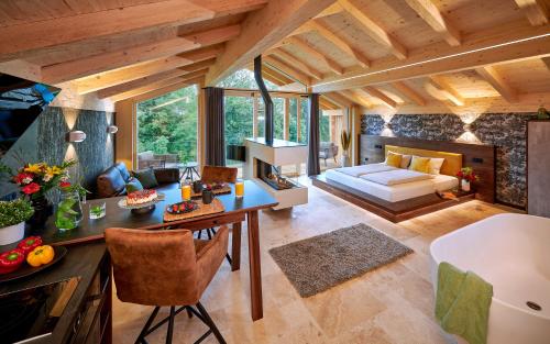 a living room with a table and a couch at ÜbermAlztal Chalet Alzblick Ferienwohnung in Altenmarkt an der Alz