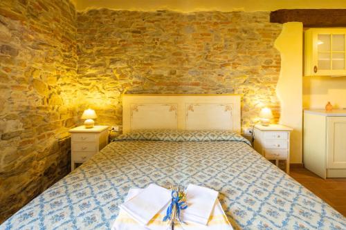 a bedroom with a bed with two towels on it at Casale Bonavita by VacaVilla in Città di Castello