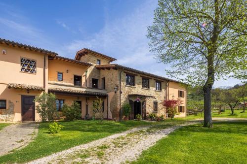 a large stone house with a grass yard at Casale Bonavita by VacaVilla in Città di Castello