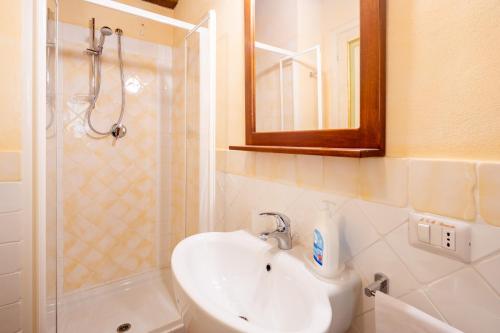a bathroom with a sink and a shower with a mirror at Casale Bonavita by VacaVilla in Città di Castello