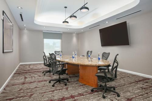 a conference room with a table and chairs at Hilton Garden Inn Dallas Arlington in Arlington
