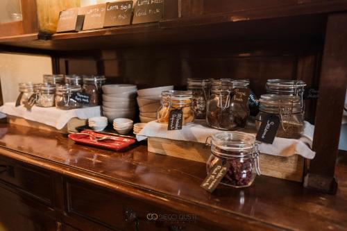 a counter with jars and plates on a table at Al Castello Resort in Sillavengo