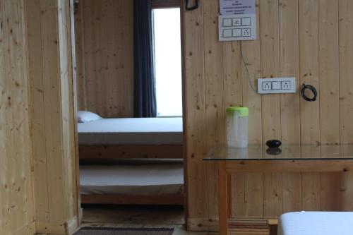 a room with two bunk beds and a window at THE GROOVE GARDEN DHANOLTi in Dhanaulti