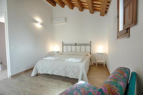 a bedroom with a bed and a couch in a room at Erice Lovely Apt with Terrace and Stunning View in Erice