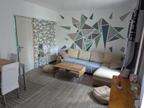 a living room with a couch and a table at Barbusse in Fleury-les-Aubrais