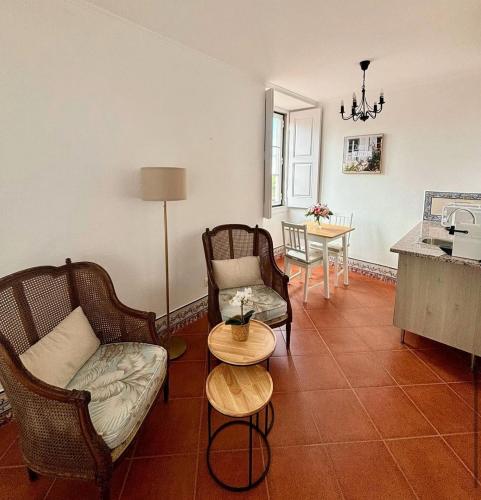 a living room with a couch and chairs and a table at CASA da VILLA STUDIO in Sintra
