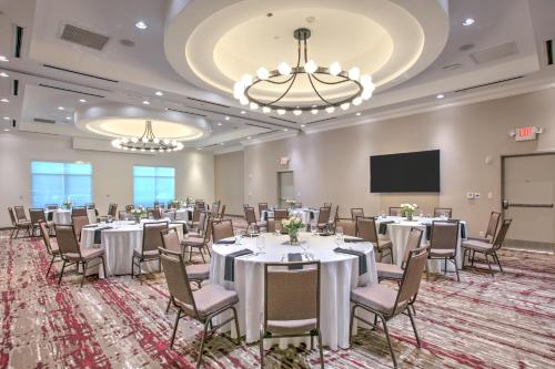 a conference room with tables and chairs and a projection screen at Hilton Garden Inn Dallas Arlington in Arlington