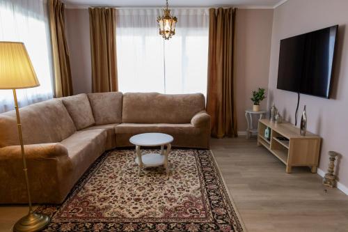 a living room with a couch and a table at Alojamento Raízes da Montanha RRAL 4596 in Madalena