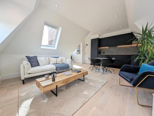 a living room with a couch and a piano at 2BR flat in Greater London with free parking in Finchley