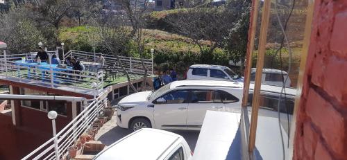 a white car is being loaded onto a boat at THE GROOVE GARDEN DHANOLTi in Dhanaulti