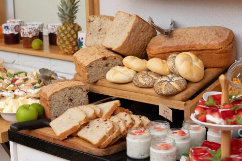 a display of bread and other foods on a table at Chaber Apartamenty in Swornegacie 