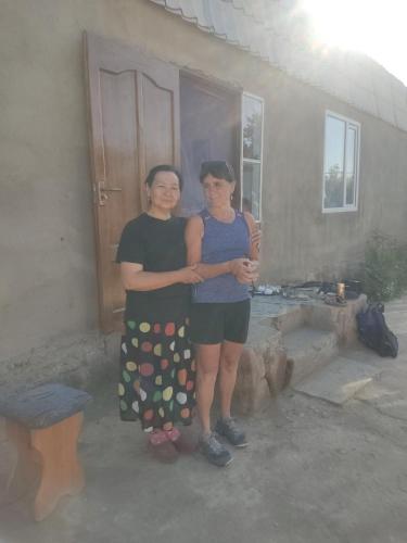 two women standing in front of a house at "Martin" guest house in Kara-Talaa