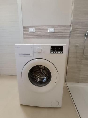 a white washing machine in a room at vacanza in Salento, La Terrazza in Surano