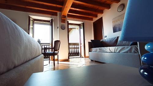 a living room with a couch and a table at La Casa sulla Roccia in Pisogne