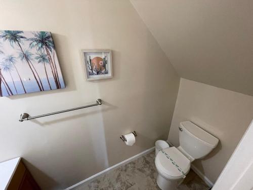 a bathroom with a toilet and a picture on the wall at Atlantic Abode - Quiet Neighborhood in AC in Atlantic City