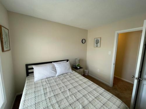 a bedroom with a large bed with two pillows at Atlantic Abode - Quiet Neighborhood in AC in Atlantic City