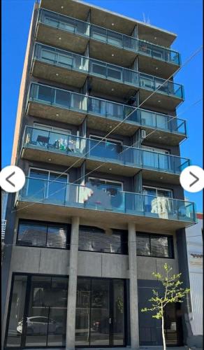 a tall apartment building with a balcony and two circles at Home Rosario in Rosario