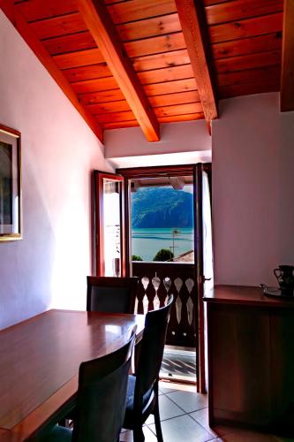 a dining room with a table and chairs and a window at La Casa sulla Roccia in Pisogne