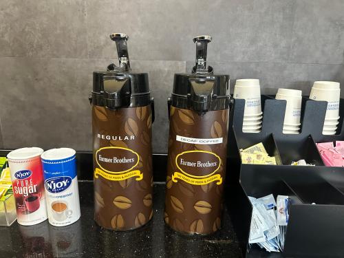 due bottiglie d'acqua appoggiate su un bancone di Super 8 by Wyndham Richfield Cleveland a Richfield