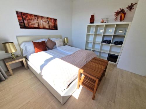 a bedroom with a bed and a table and shelves at The Lake House in Caslano