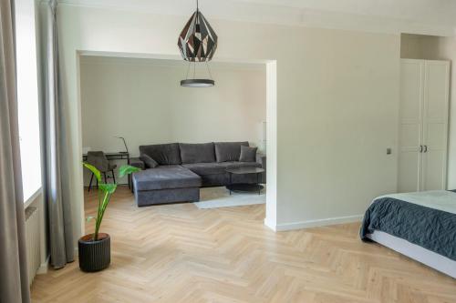 a living room with a couch and a table at Stylish apartment in the heart of Tallinn, free parking in Tallinn