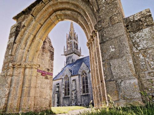 an old church with a tower in the background at Gite Villa Morgane - A 250 m de la plage de Pentrez in Saint-Nic