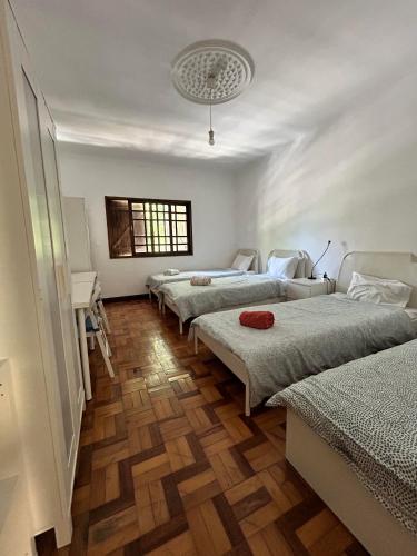 a group of four beds in a room at Asprela Guest House in Porto