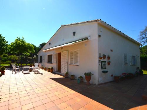 a white house with a patio in front of it at Can Torrent 10 Km Lloret De Mar in Vidreres