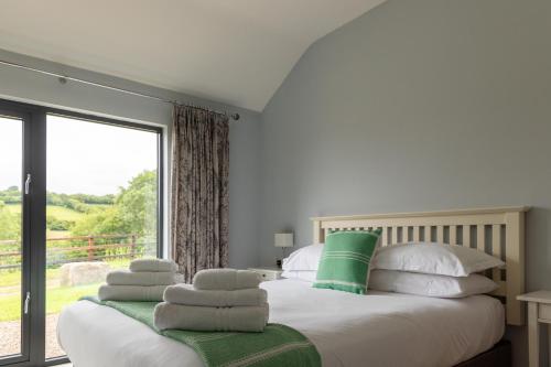 a bedroom with a bed and a large window at Welsh Marches at Upper Glyn Farm in Chepstow