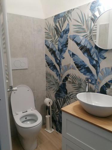 a bathroom with a white toilet and a sink at Camera Rondini di Casa Mosaico in Volterra