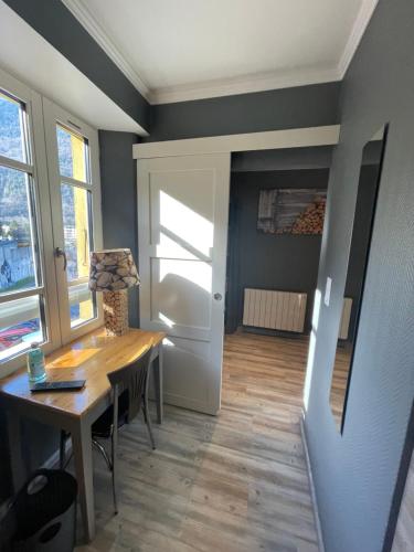 - une salle à manger avec une table et une porte dans l'établissement la montagnette T2 MAISON EN TRAVAUX DE 10H A 17H, à Moutiers