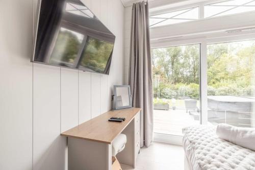 a living room with a desk and a window at Luxury Lodge with Hot Tub in Windsor Marina - By Tempstay in Windsor