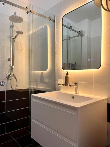 a bathroom with a sink and a mirror at Viluni Coast Apartment in Velipojë